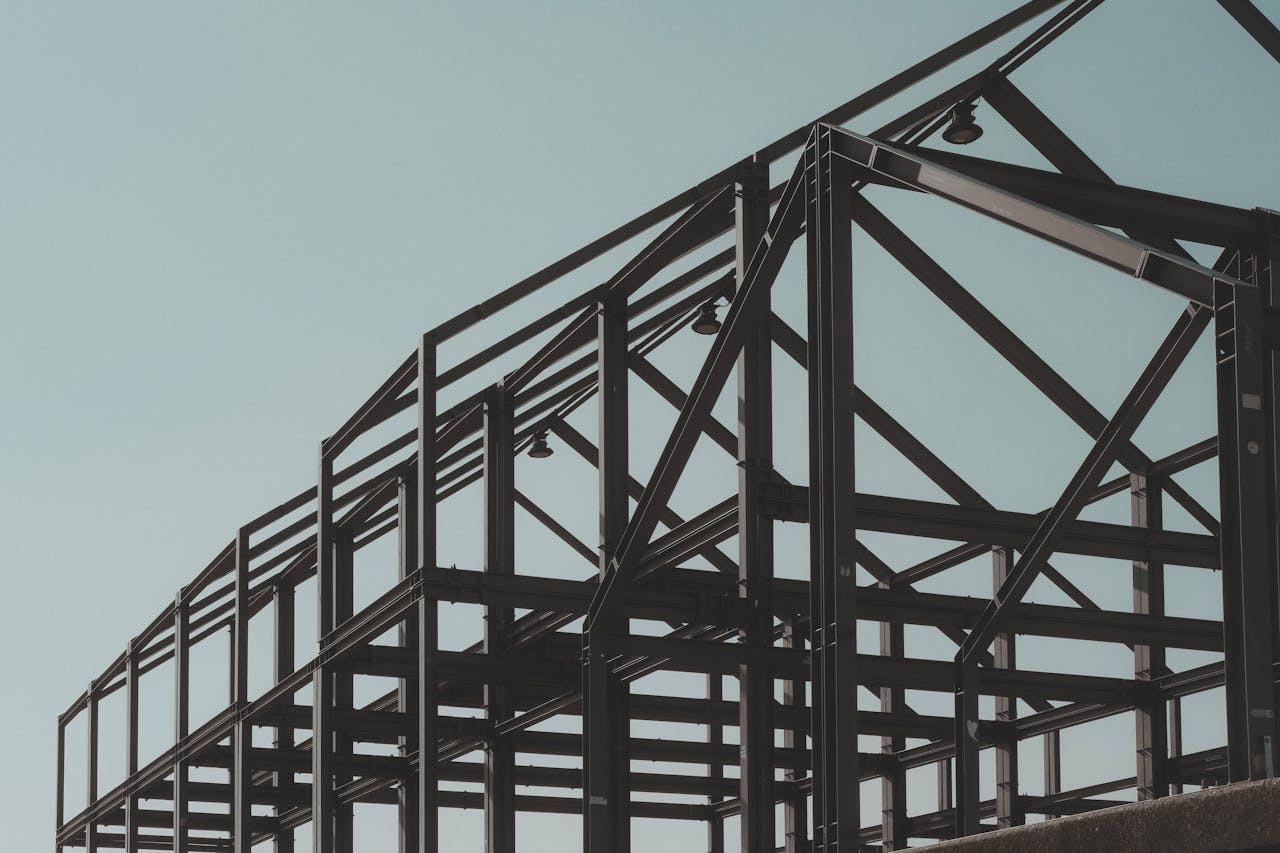 Modern steel framework structure under clear sky, showcasing architectural design.